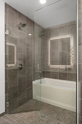 a bathroom with a bathtub and a shower