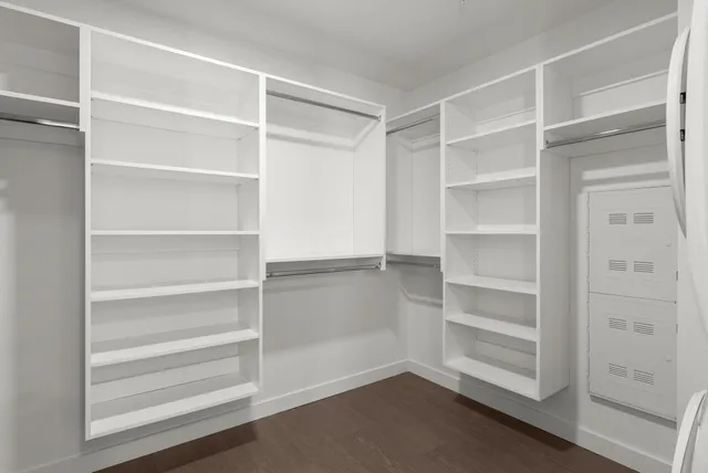 a view of walk in closet with empty racks