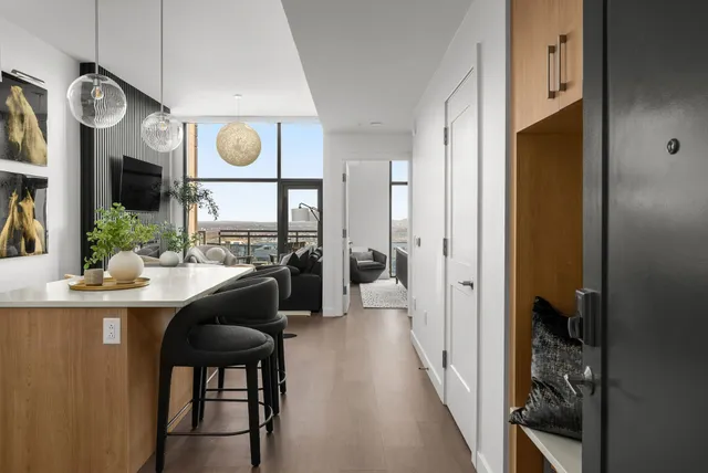 a dining room with wooden floor and a large window