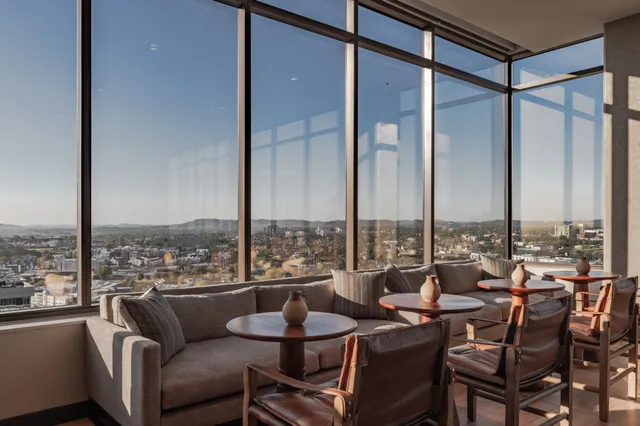 a living room with furniture and a mirror