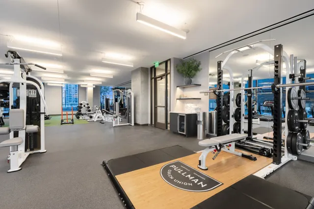 a room with gym equipment and lots of equipment