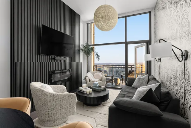 a living room with furniture a fireplace and a flat screen tv