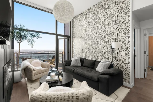 a living room with furniture and a large window