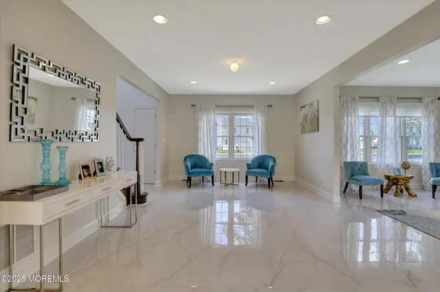 a living room with furniture and painting on the wall