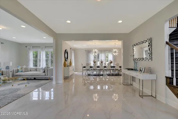 a view of a dining room with furniture and chandelier