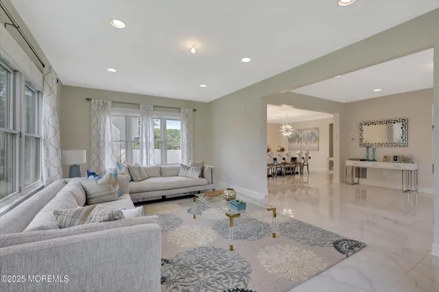 a view of a dining room with furniture and a chandelier