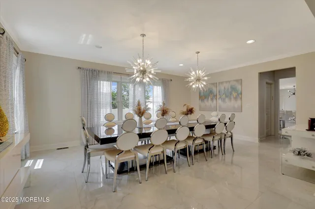 a view of a dining room with furniture and chandelier