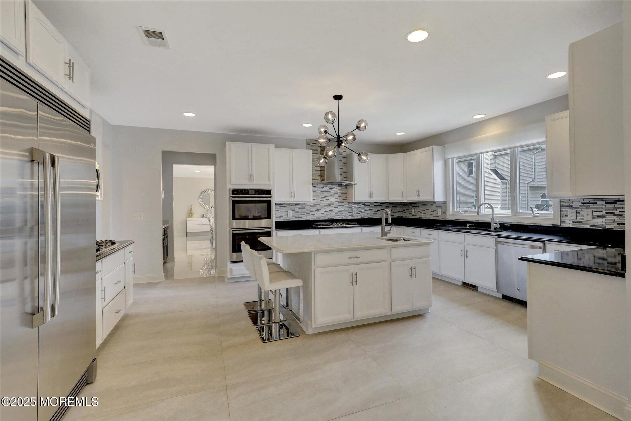 1 Country Club Drive Deal, NJ 07723 - Photo 23 of 65 a large kitchen with cabinets and stainless steel appliances