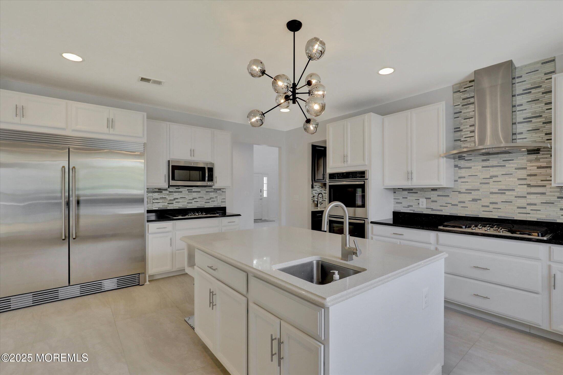 1 Country Club Drive Deal, NJ 07723 - Photo 24 of 65 a kitchen with stainless steel appliances a sink a stove a refrigerator cabinets and a counter top space