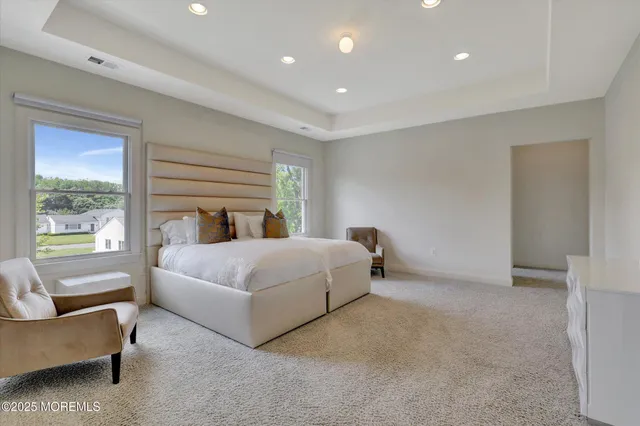 a bathroom with a granite countertop bathtub a shower and a toilet
