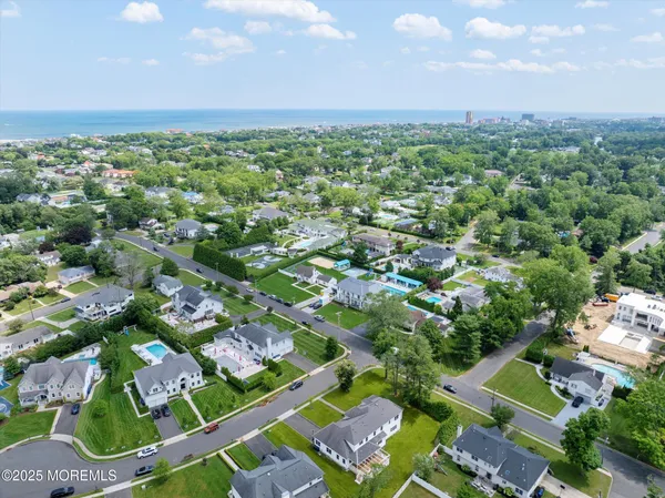 an aerial view of a house with a garden and swimming pool