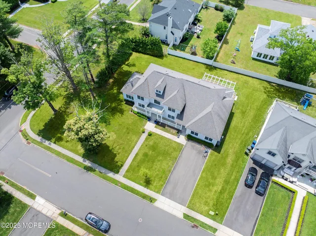 an aerial view of a house with a garden and swimming pool