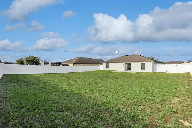 a house view with swimming pool in front of it