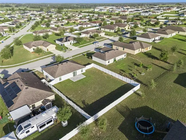 an aerial view of a house with a yard