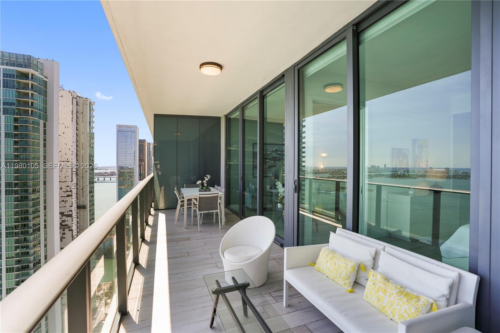 480 Northeast 31st Street, Unit 3906 Miami, FL 33137 - Photo 11 of 38 a balcony with table and chairs