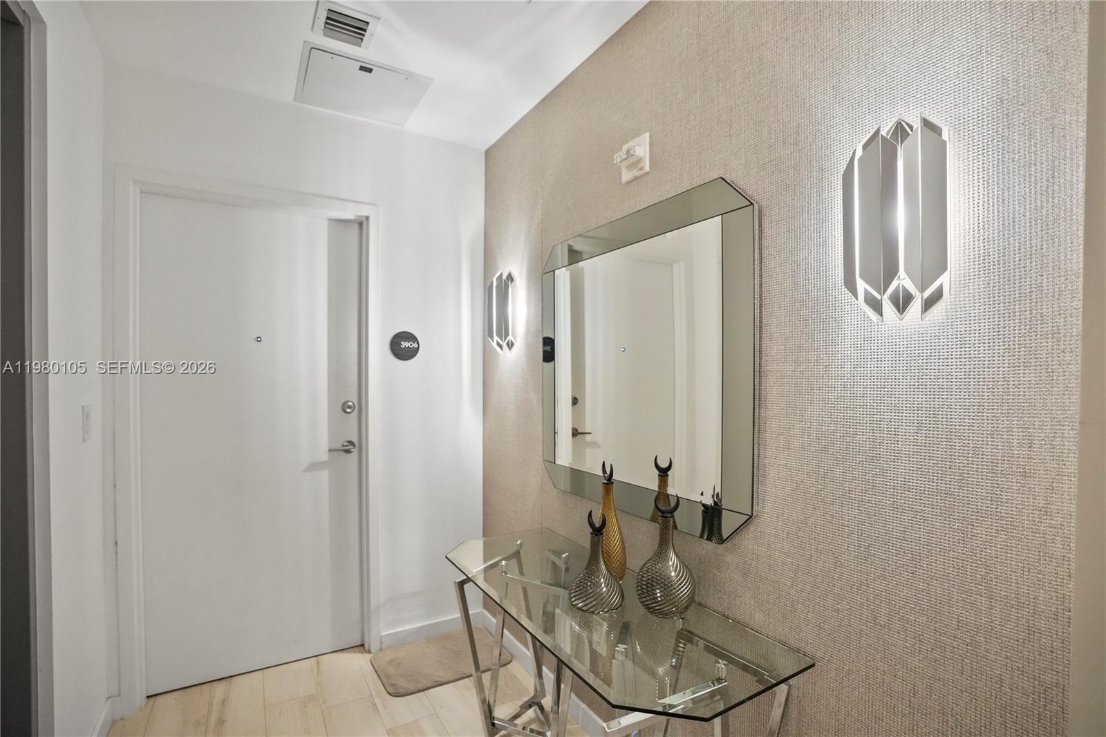 480 Northeast 31st Street, Unit 3906 Miami, FL 33137 - Photo 13 of 38 a bathroom with a glass shower door