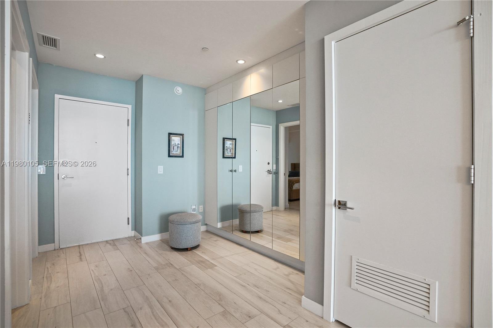 480 Northeast 31st Street, Unit 3906 Miami, FL 33137 - Photo 15 of 38 a view of a hallway with wooden floor and a bathroom