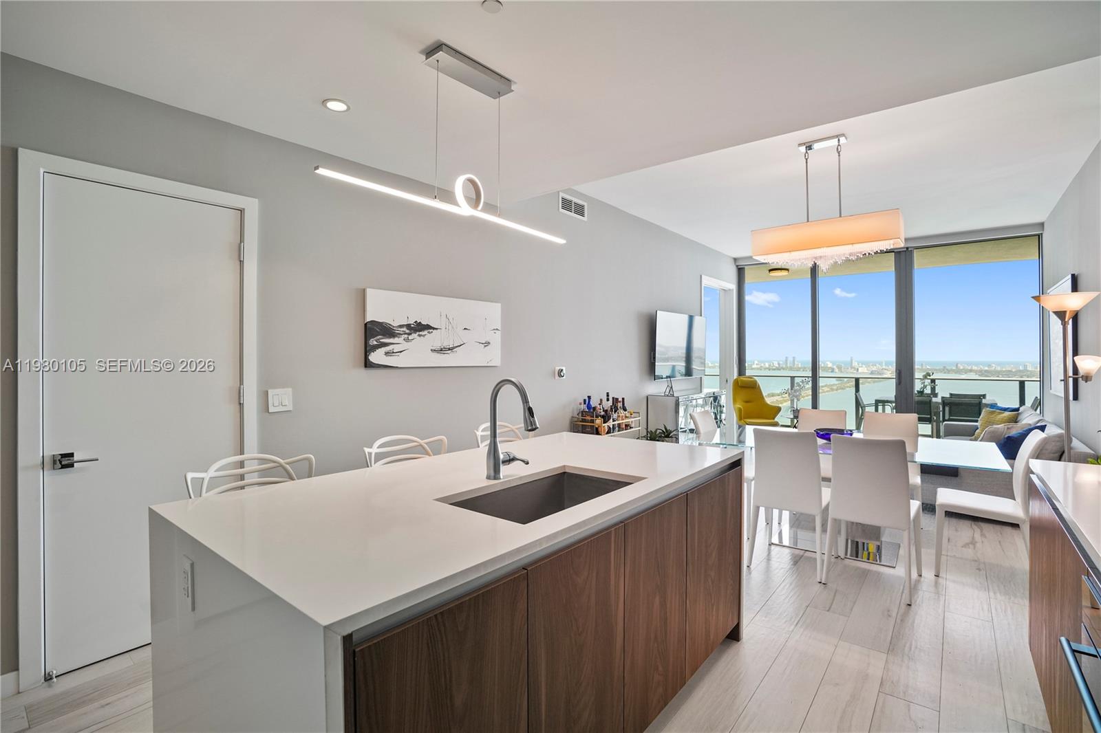 480 Northeast 31st Street, Unit 3906 Miami, FL 33137 - Photo 16 of 38 a room with lots of counter space windows and a chandelier