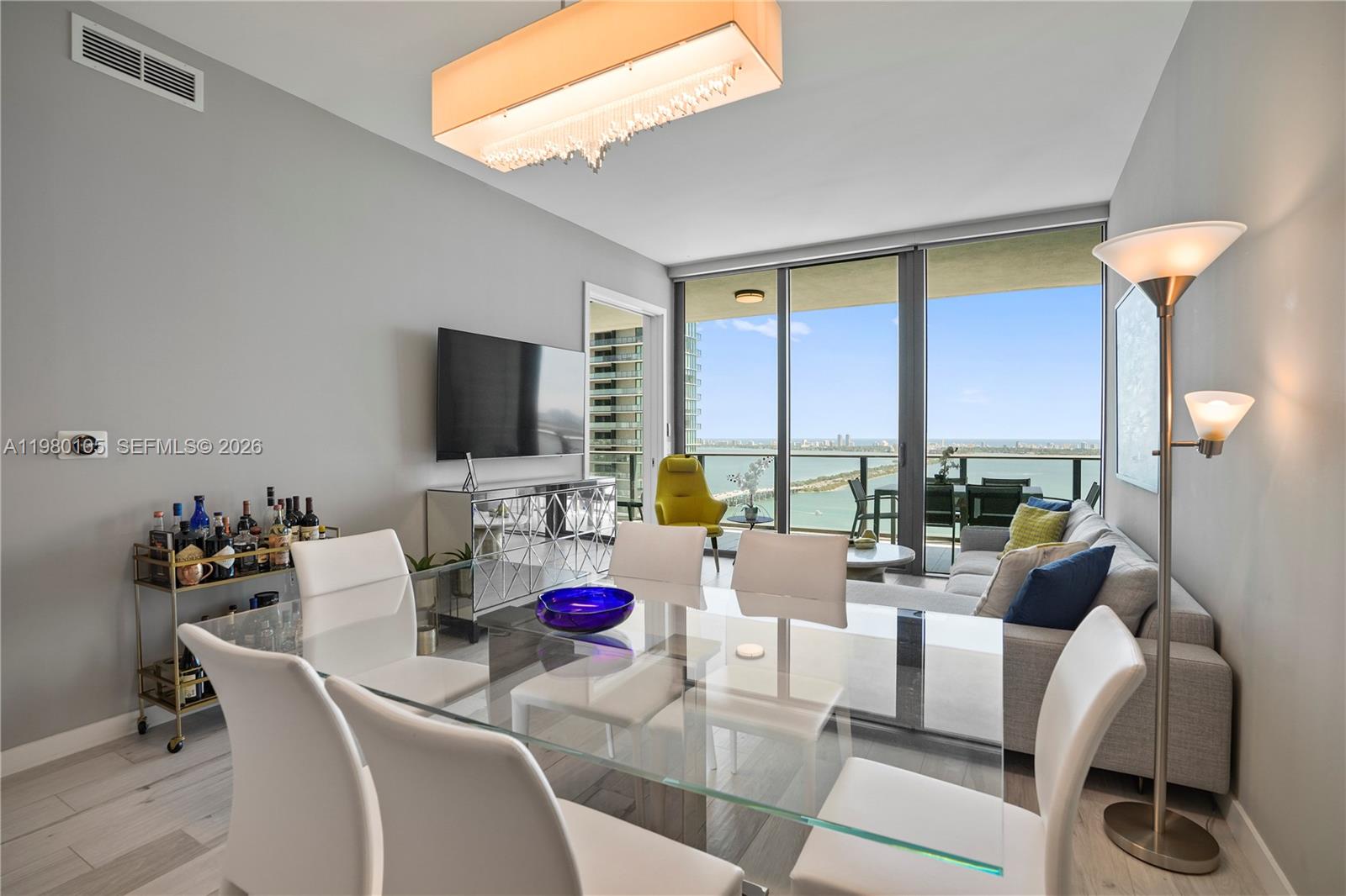 480 Northeast 31st Street, Unit 3906 Miami, FL 33137 - Photo 21 of 38 a living room with furniture and a flat screen tv