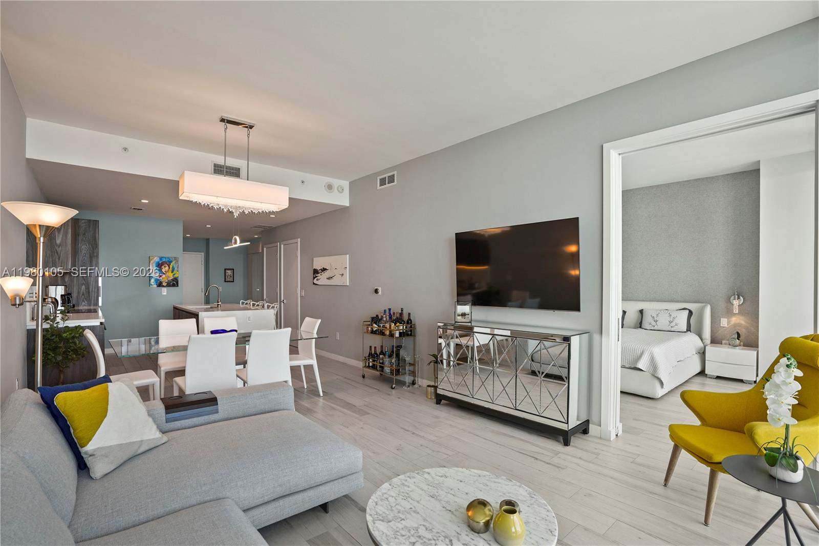 480 Northeast 31st Street, Unit 3906 Miami, FL 33137 - Photo 22 of 38 a living room with furniture and a flat screen tv