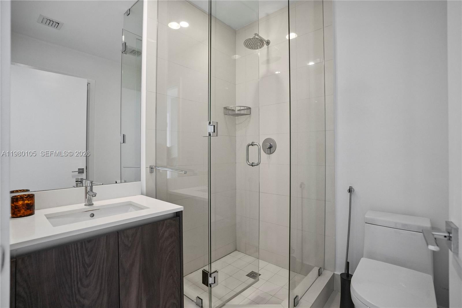 480 Northeast 31st Street, Unit 3906 Miami, FL 33137 - Photo 25 of 38 a bathroom with a sink toilet and shower