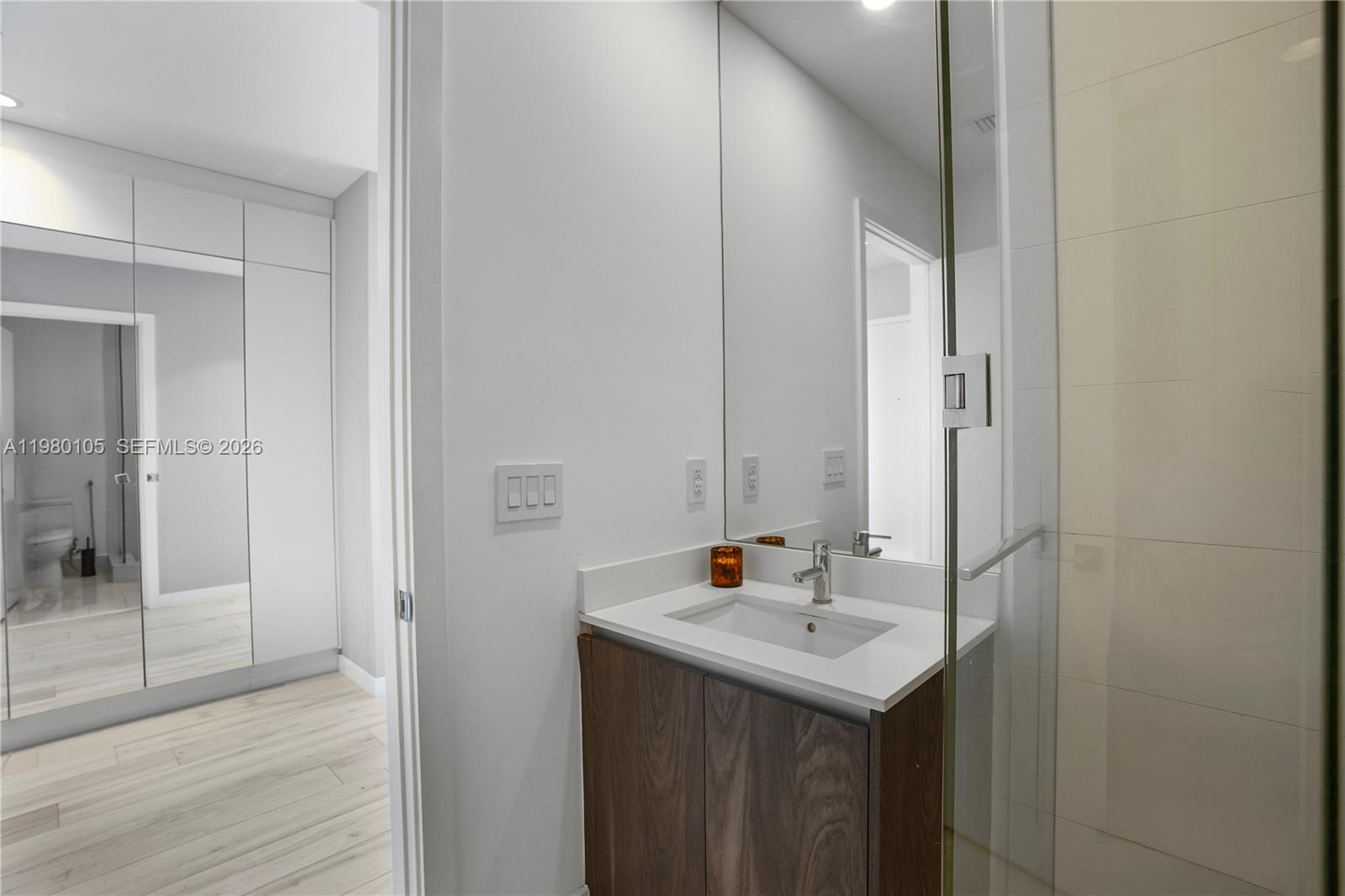 480 Northeast 31st Street, Unit 3906 Miami, FL 33137 - Photo 26 of 38 a bathroom with a sink and a mirror