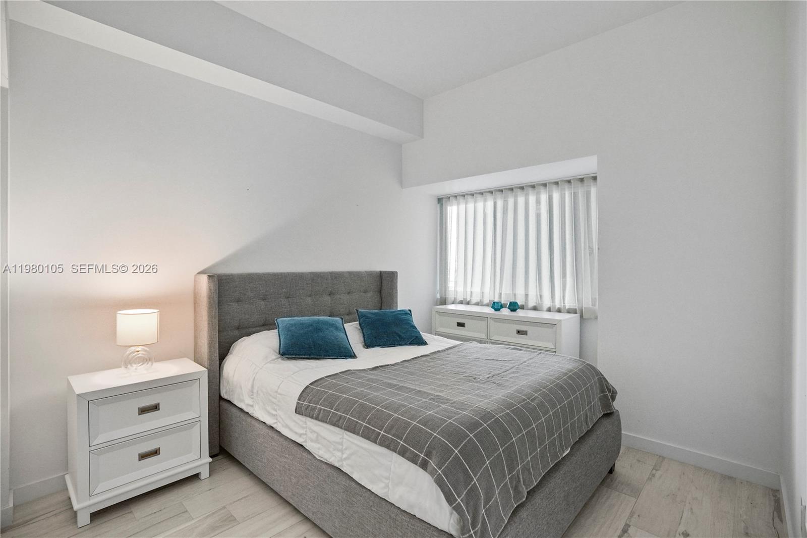 480 Northeast 31st Street, Unit 3906 Miami, FL 33137 - Photo 27 of 38 a bedroom with a bed and a dresser