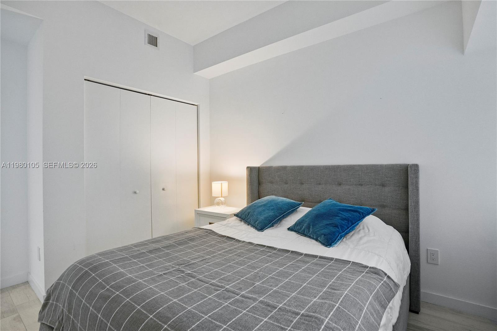 480 Northeast 31st Street, Unit 3906 Miami, FL 33137 - Photo 28 of 38 a bedroom with a bed and a night stand