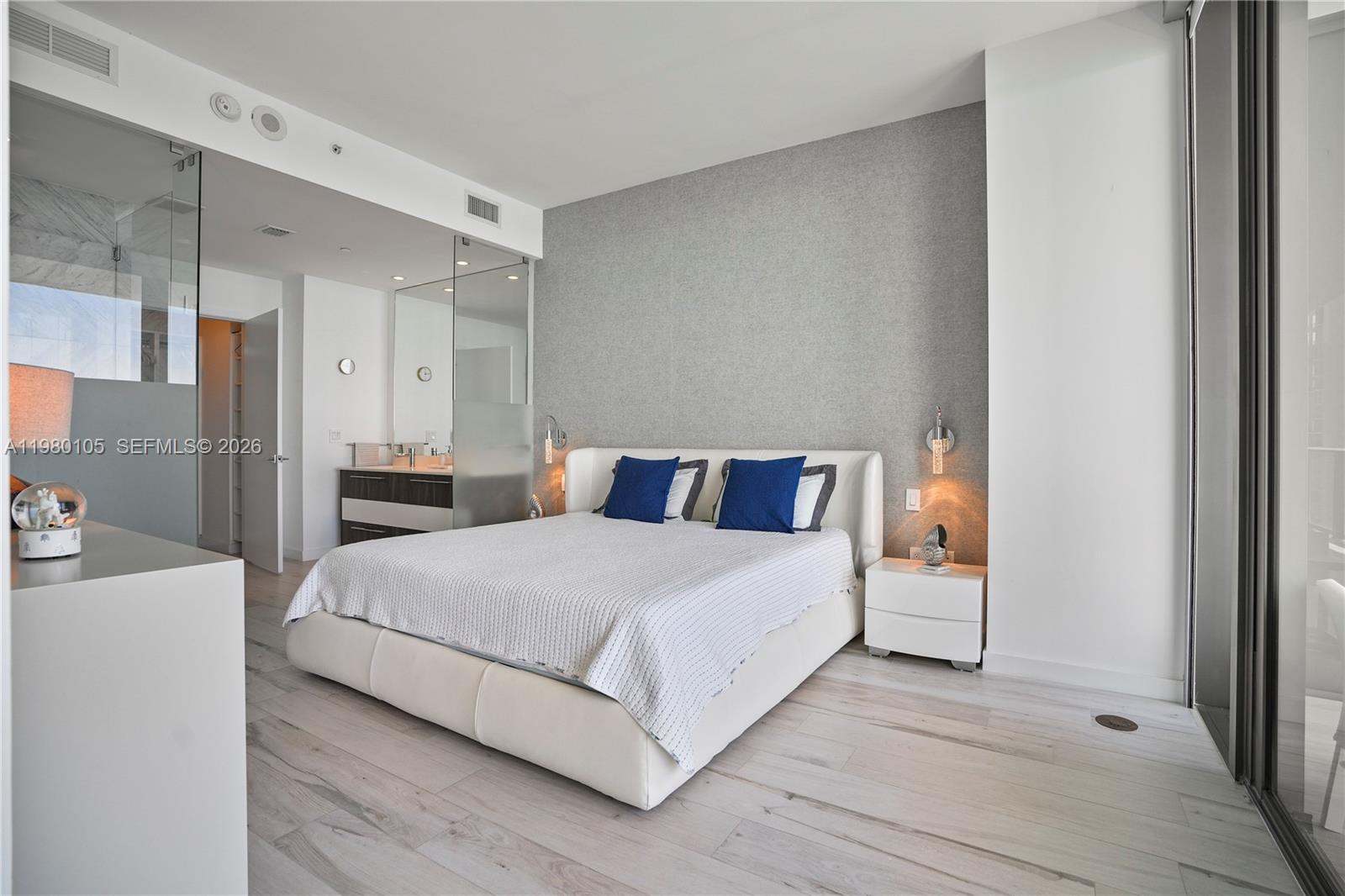 480 Northeast 31st Street, Unit 3906 Miami, FL 33137 - Photo 31 of 38 a bedroom with a bed and a mirror