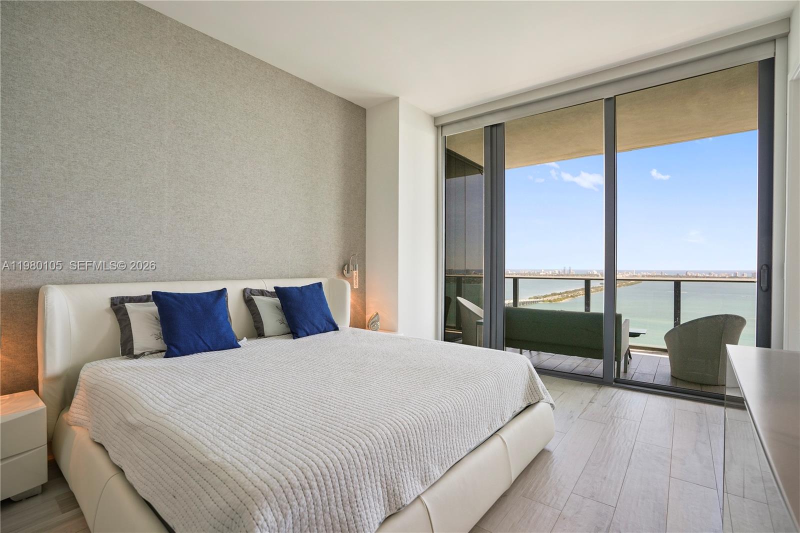 480 Northeast 31st Street, Unit 3906 Miami, FL 33137 - Photo 32 of 38 a bedroom with a large bed and a large window
