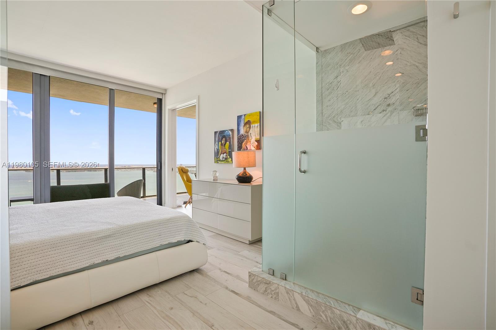 480 Northeast 31st Street, Unit 3906 Miami, FL 33137 - Photo 36 of 38 a bedroom with a large bed and a window