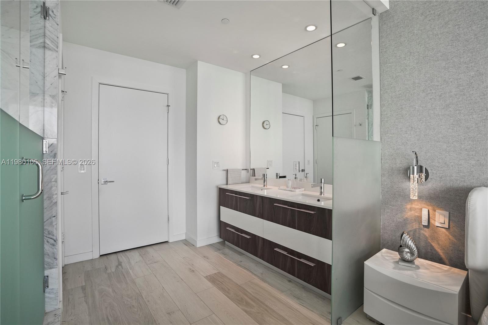 480 Northeast 31st Street, Unit 3906 Miami, FL 33137 - Photo 38 of 38 a bathroom with a double vanity sink and mirror