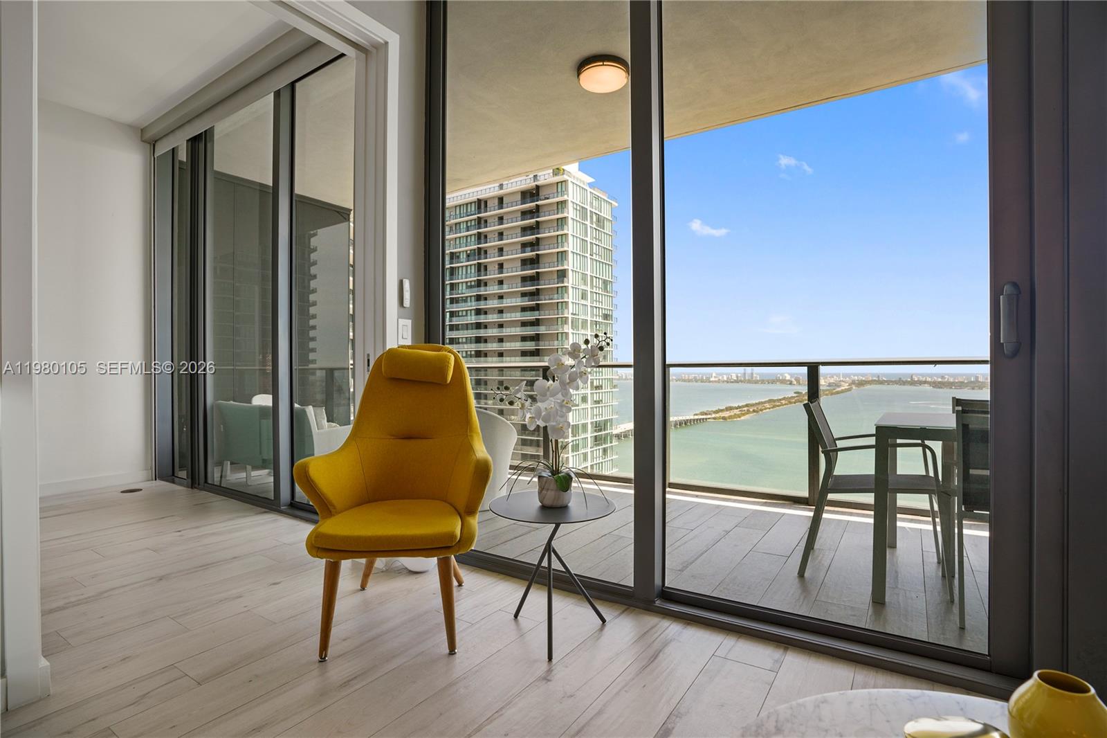 480 Northeast 31st Street, Unit 3906 Miami, FL 33137 - Photo 7 of 38 a view of a porch with furniture and wooden floor