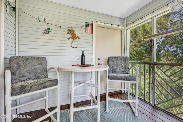 a view of a chairs and table in the balcony
