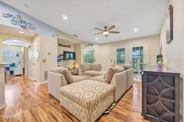 a living room with furniture and a wooden floor