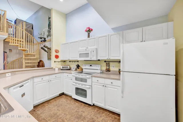 a white refrigerator freezer sitting in a kitchen