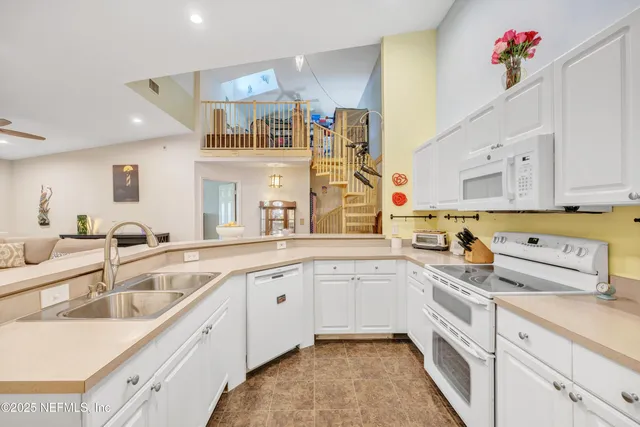 a kitchen with cabinets a sink and appliances