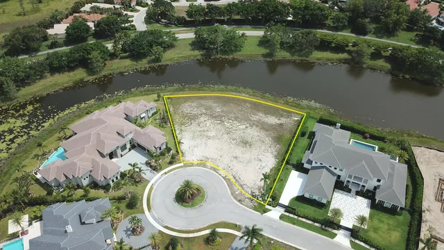 an aerial view of a house with outdoor space and lake view