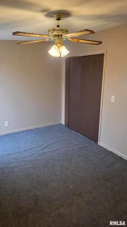 a view of a chandelier fan and entryway