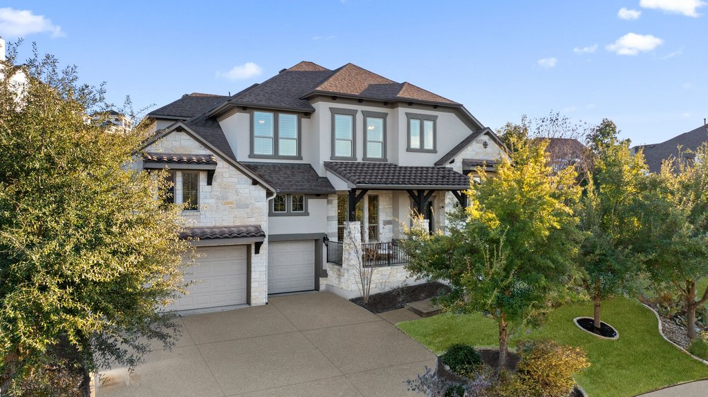 a front view of a house with a yard garage and outdoor seating