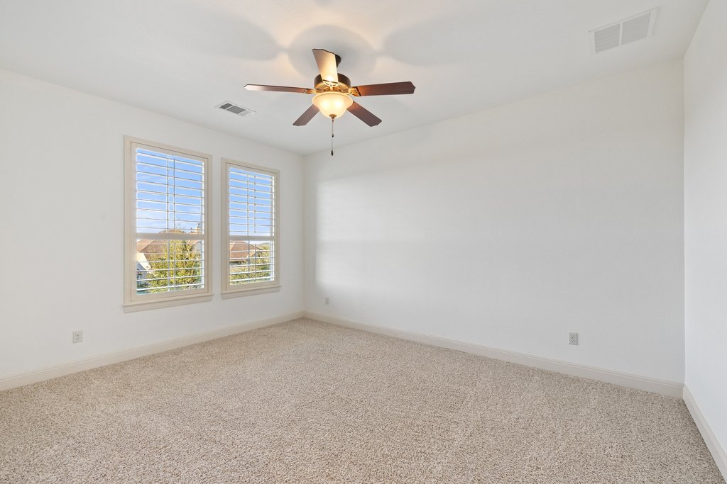 5804 Davenport Divide Road Austin, TX 78738 - Photo 29 of 40 an empty room with windows and fan