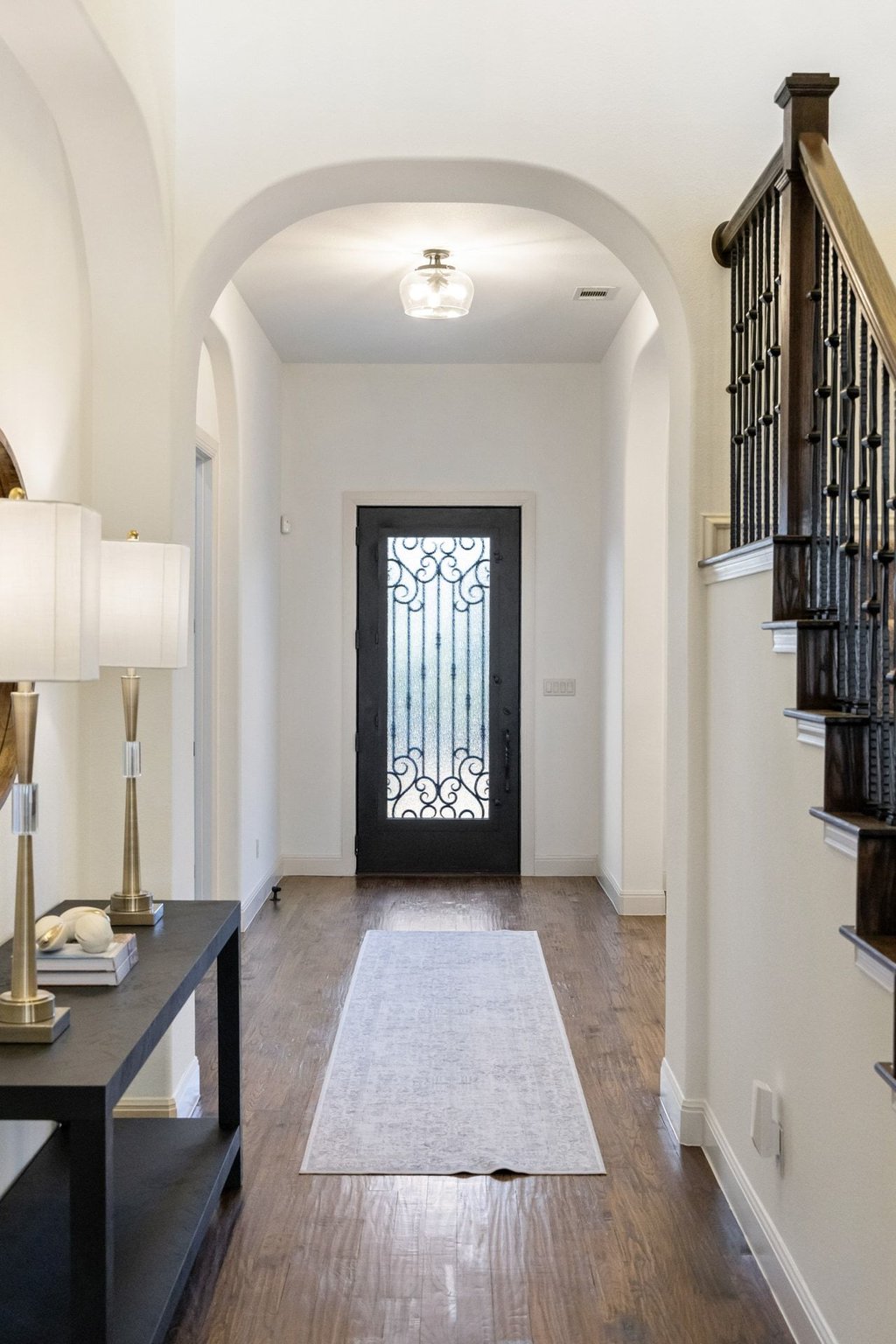 5804 Davenport Divide Road Austin, TX 78738 - Photo 7 of 40 a view of a hallway to a livingroom with wooden floor and staircase