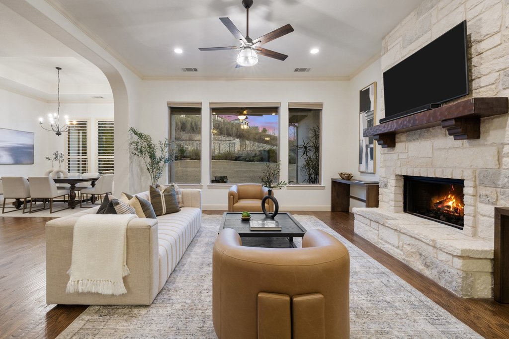 5804 Davenport Divide Road Austin, TX 78738 - Photo 9 of 40 a living room with furniture a fireplace and a flat screen tv