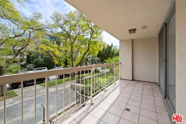 a balcony with trees in front of it