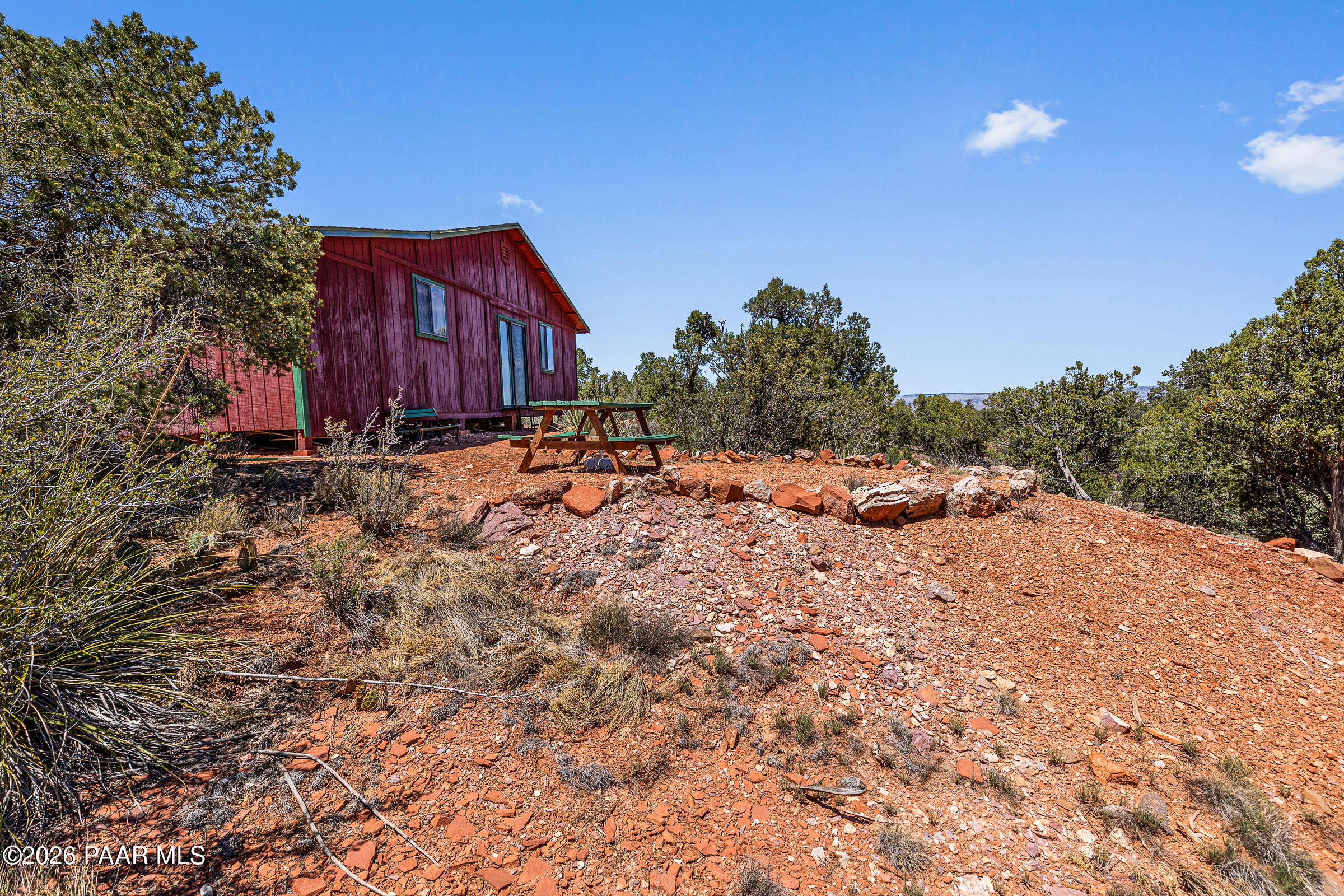 33749 West Whiskey River Road, Unit 21 Seligman, AZ 86337 - Photo 7 of 41 a backyard of a house with table and chairs