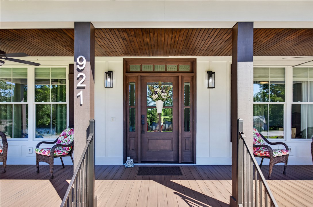 921 Falling Waters Lane Seneca, SC 29672 - Photo 2 of 46 Welcome guests to a charming front porch, featuring rich wooden flooring and stately columns.