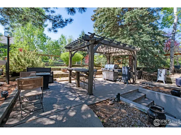a view of a patio with table and chairs under an umbrella