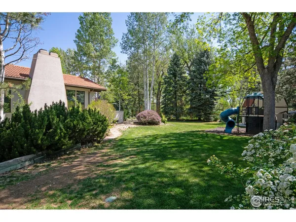 a backyard of a house with table and chairs