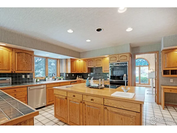 a kitchen with stainless steel appliances a sink stove and cabinets