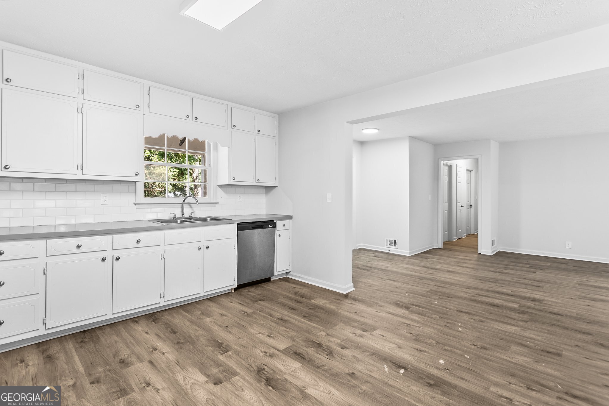 3620 Knoll Crest Trail Buford, GA 30519 - Photo 17 of 47 a kitchen with granite countertop white cabinets and white appliances
